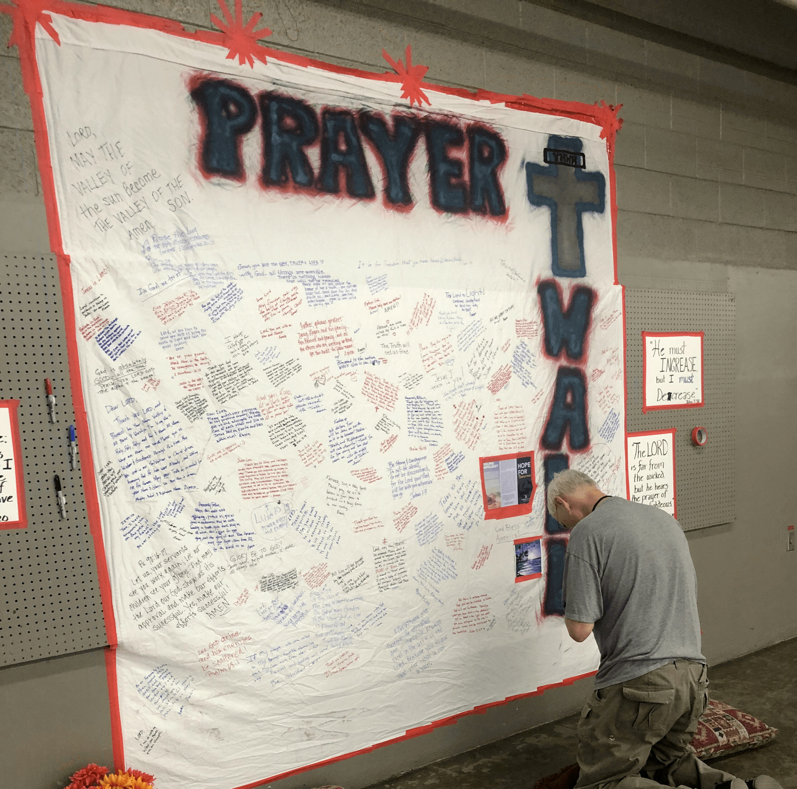 Man praying at wall